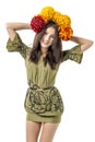 Slender young cheerful girl brown hair dances with a bouquet of colorful flowers on her head Royalty Free Stock Photo