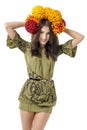 Slender young cheerful girl brown hair dances with a bouquet of colorful flowers on her head Royalty Free Stock Photo