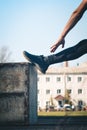 A slender young man in black clothes and sunglasses is exercising outdoors. fitness athlete on the sports field. training. Royalty Free Stock Photo