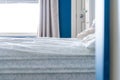 A slept-in bed with a messy sheet, no blankets, in a blue and white bedroom home design Royalty Free Stock Photo