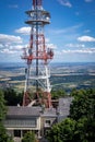 Radio and TV mast, surrounded with trees, on the top of Sleza mountain, Sudetes Foreland, Poland. Royalty Free Stock Photo