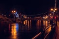 Slgo, Ireland: 12.05.2021: Beautiful decorated and illuminated buildings on river side and reflection in water. Town night scene. Royalty Free Stock Photo