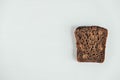 Slic of fresh brown bread with raisins on a white wooden background. Top view. Copy, empty space for text Royalty Free Stock Photo