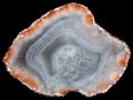 Slice of agate geode with red zeolites on the periphery