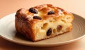 Slice of babka bread pudding topped with raisins on plate. Royalty Free Stock Photo
