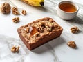 A slice of banana walnut bread topped with syrup, surrounded by walnuts and a banana Royalty Free Stock Photo