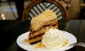 Slice of Banoffee Pie Cake with Fluffy Whipped Cream on a White Plate