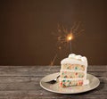 Slice of Birthday Cake with Sparkler Royalty Free Stock Photo