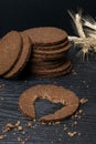 Slice of black bread with a cut in the shape of a heart on dark wooden background. View from above. Conceptual photo. Royalty Free Stock Photo