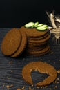 Slice of black bread with a cut in the shape of a heart on dark wooden background. View from above. Conceptual photo. close up Royalty Free Stock Photo