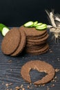 Slice of black bread with a cut in the shape of a heart on dark wooden background. View from above. Conceptual photo. close up Royalty Free Stock Photo