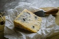 Slice of blue cheese cheese on wooden board with cheese knife, closeup view Royalty Free Stock Photo