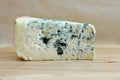 Slice of blue cheese on wooden background