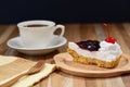 Slice of blueberry cheese cake on wooden table