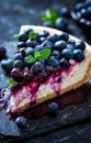 Slice of Blueberry Cheesecake With Fresh Berries on a White Plate, Elegantly Presented Royalty Free Stock Photo