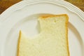 Slice bread bite on white plate Royalty Free Stock Photo