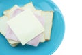 Slice of bread with cheese and ham on blue plate with white back Royalty Free Stock Photo