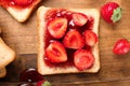 Slice of bread with delicious strawberry jam on wooden board, top view Royalty Free Stock Photo