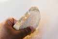 Man holding slice of bread with mold on light background. Food not suitable for consumption Royalty Free Stock Photo