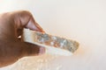 Man holding slice of bread with mold on light background. Food not suitable for consumption Royalty Free Stock Photo