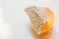 Piece of moldy bread on light background. Food not suitable for consumption Royalty Free Stock Photo