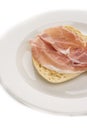 Slice bread with parma ham on white plate closeup Royalty Free Stock Photo