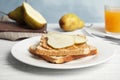 Slice of bread with peanut butter and pear on wooden table Royalty Free Stock Photo