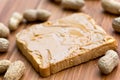 Slice of bread with peanut butter spread on wooden Royalty Free Stock Photo