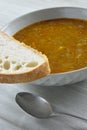 Slice of bread on plate of lentil soup