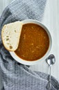 Slice of bread on plate with lentil soup on towel Royalty Free Stock Photo