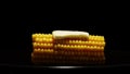 Slice of butter on sweetcorn cob on a black background Royalty Free Stock Photo