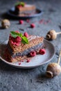 Cacao sponge cake with poppy seeds and coconut filling, decorated with freeze - dried raspberries Royalty Free Stock Photo