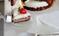 A slice of cake of three different layers with strawberries on a small plate Royalty Free Stock Photo