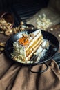 Slice of carrot cake with cream cheese and walnuts. The restaurant or cafe atmosphere. Vintage