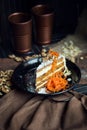 Slice of carrot cake with cream cheese and walnuts. The restaurant or cafe atmosphere. Vintage