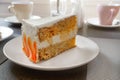 Slice of carrot cake on a white plate in a cafe Royalty Free Stock Photo