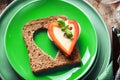 Slice of cereal toast bread with cut out heart shape. Royalty Free Stock Photo