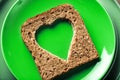 Slice of cereal toast bread with cut out heart shape. Royalty Free Stock Photo