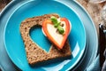 Slice of cereal toast bread with cut out heart shape. Royalty Free Stock Photo