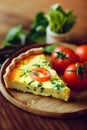 A slice of cheese and tomato pizza on a cutting kitchen wooden board, blurred background Royalty Free Stock Photo