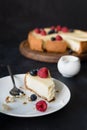 Slice of cheesecake with missing bite on white plate Royalty Free Stock Photo