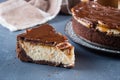 Slice of Cheesecake Snickers with chocolate, caramel, peanut paste, Nougat and Peanut Layered Cake Royalty Free Stock Photo