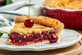 slice of cherry pie, Flaky Crust, piece on a plate and the whole homemade cherry pie, Long banner format. top view Royalty Free Stock Photo