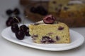 Slice of Cherry yogurt cake. Delicious yoghurt cake topped with fresh cherries Royalty Free Stock Photo