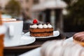 Slice of chocolate cake, Cutlery steak basket and donot with coffee on the table