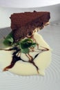 Slice of chocolate cake with vanilla ice cream, caramel and mint Royalty Free Stock Photo