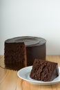 Slice Of Chocolate Cake On Wooden Table With White Background And Copy Space
