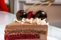 Slice Chocolate caramel cake with cherries on white plate Royalty Free Stock Photo