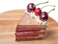 Slice Chocolate caramel cake with cherries on wooden board plate Royalty Free Stock Photo