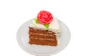 Slice of chocolate cream cake with rose Isolated on white Royalty Free Stock Photo